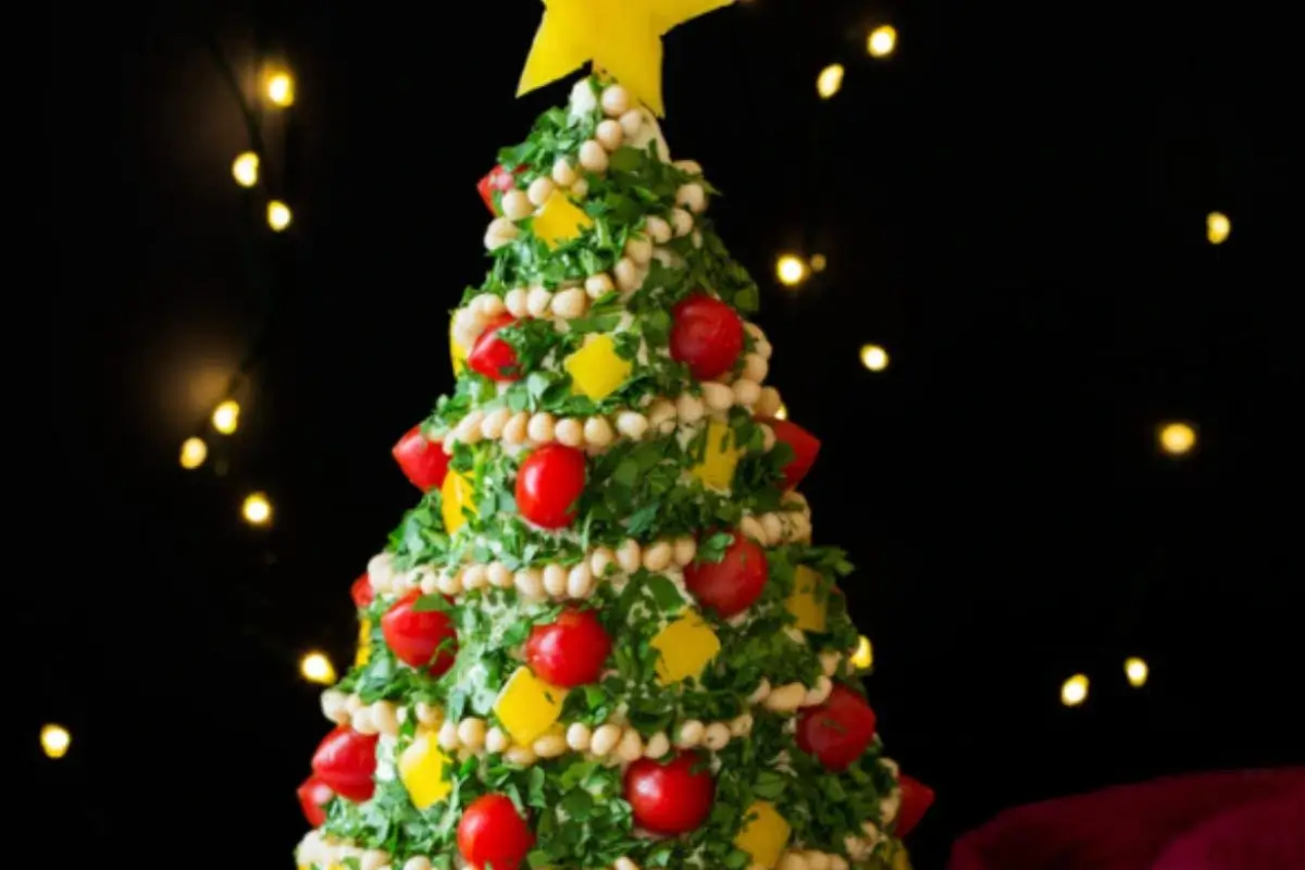 Festive Christmas Tree Cheeseball with herbs, cream cheese, and holiday decorations.