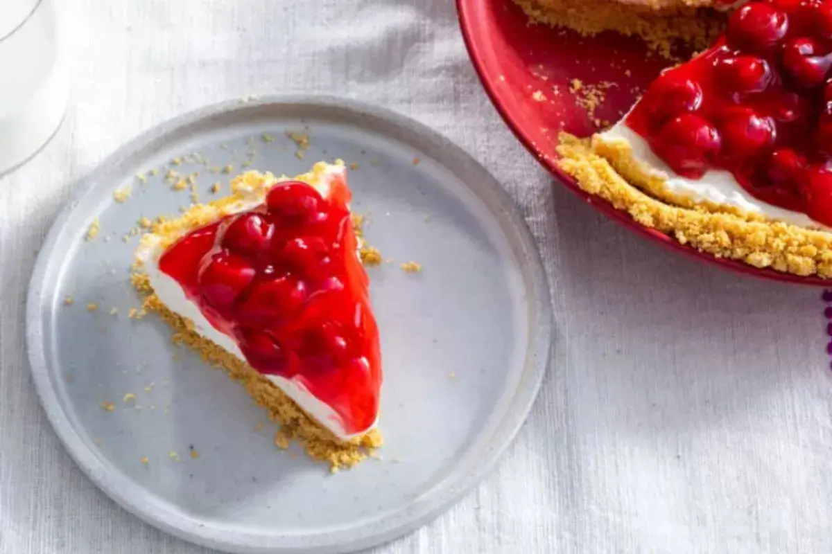 Classic no-bake cheesecake with graham cracker crust and fresh berry topping.