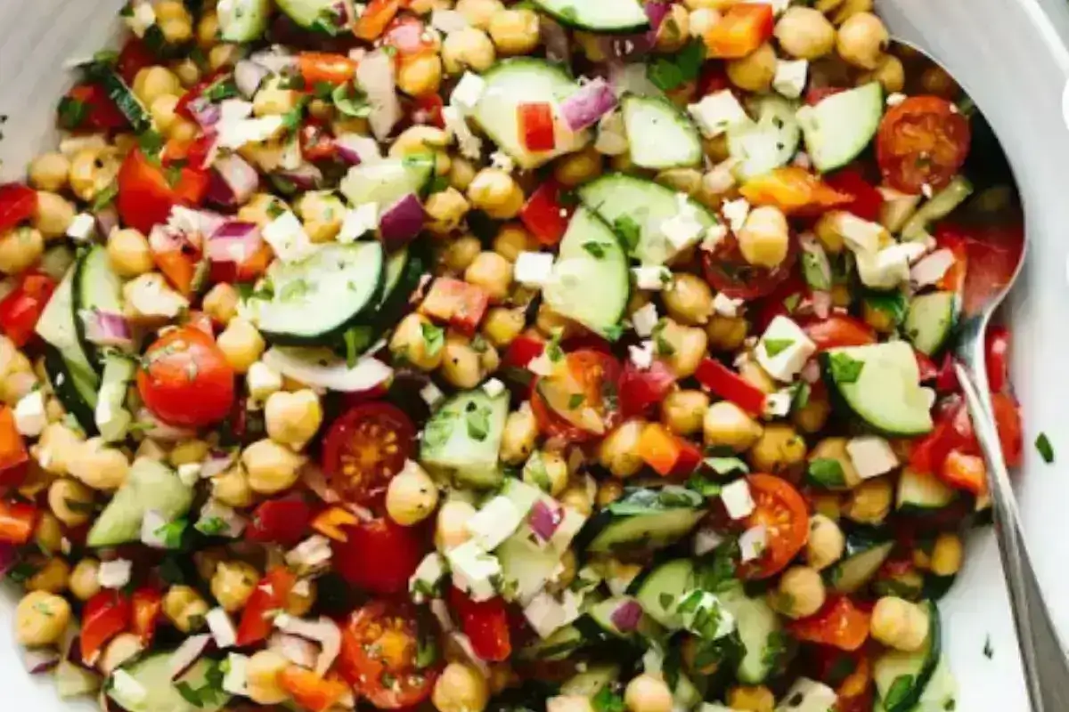 Mediterranean chickpea salad with za’atar fried eggplant, garnished with fresh parsley and mint